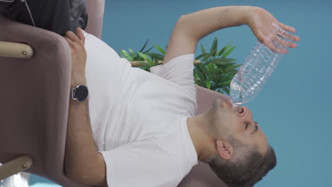 Vertical-video-of-The-man-who-drinks-water.